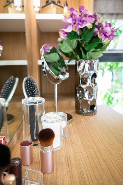 istock Cosmetics and brush set on wooden dressing table. Concept interior for Make-up space and beauty accessories. 1126057603