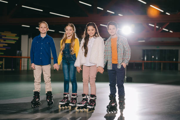 istock Cute smiling children in roller skates standing on spacious roller rink 1126058491