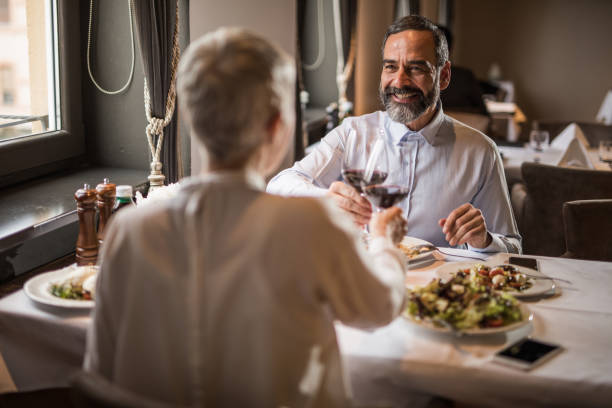 istock Happy senior couple talking while toasting in a restaurant. 1126058494