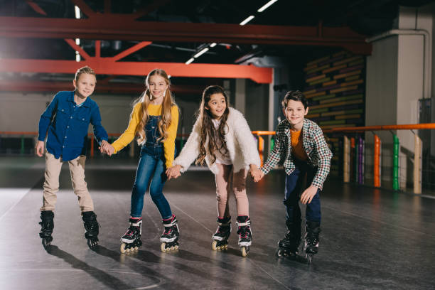 istock Adorable smiling children preparing to start moving on roller skates 1126058503