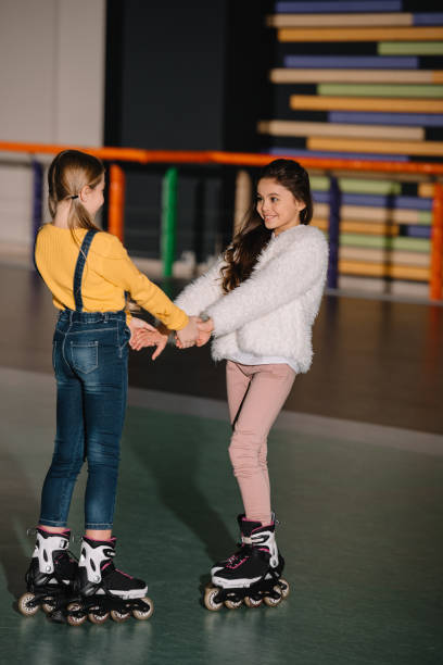 istock Pretty smiling children in roller skates, standing in spacious roller rink 1126058520
