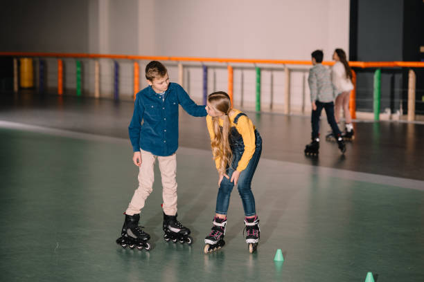 istock Joyful kids practicing roller skating on rink together 1126058597