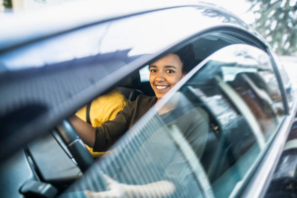 istock Two young adults sitting in the car and driving 1126058652