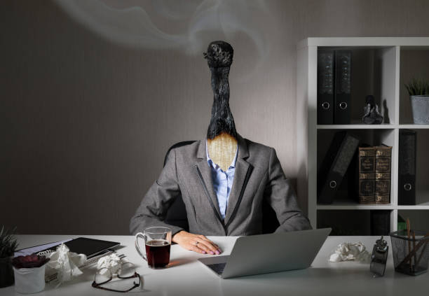 conceptual photo illustrating burnout syndrome at work - burning the candle at both ends imagens e fotografias de stock