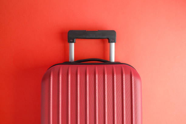 istock Luggage on red background minimalistic vacation concept. 1126060505
