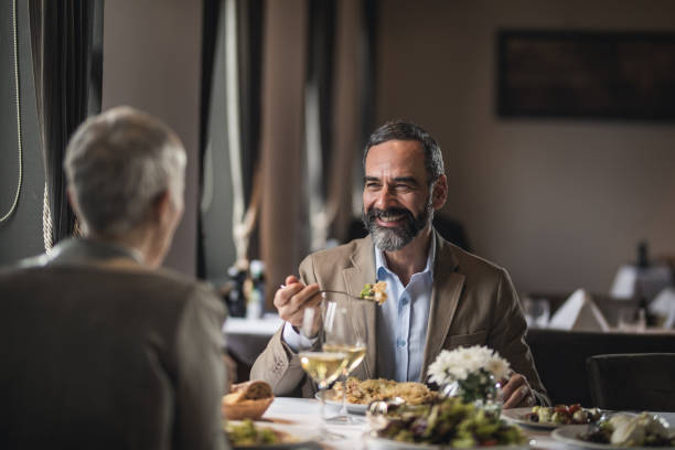 istock Happy mature couple talking during lunch time in a restaurant. 1126060514