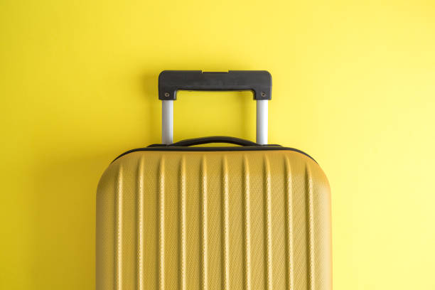 istock Luggage on yellow background minimalistic vacation concept. 1126060526