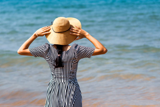 istock Woman walking by the seaside 1126060919