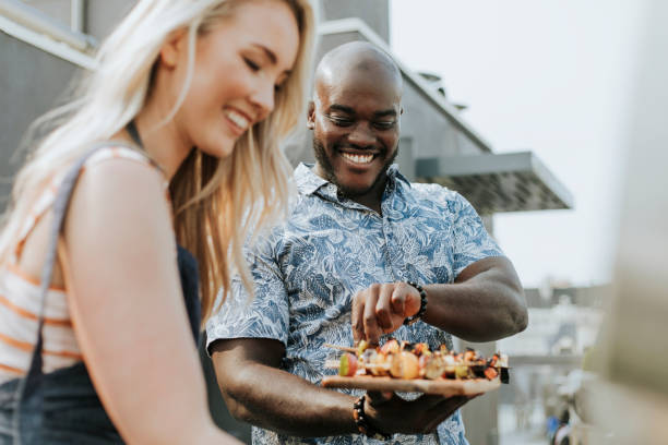 istock Happy couple preparing barbeque skewers 1126060969