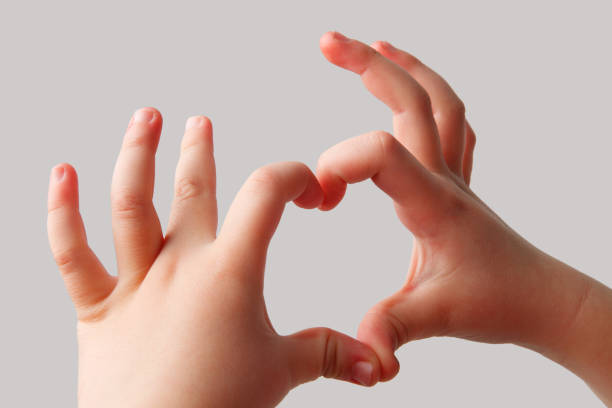 istock Heart shape from the fingers of a child 1126061987