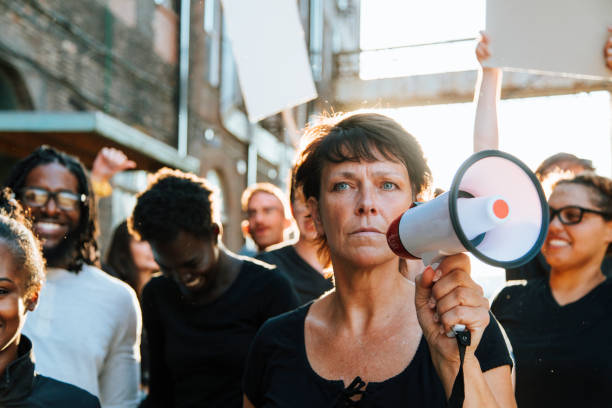 istock Feminist with a megaphone at a protest 1126062393