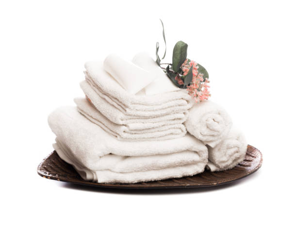 istock Stack of clean white soft towels with flower on white background - Image 1126063143