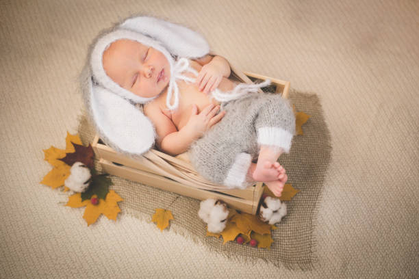 istock Newborn boy in a box in a bunny suit 1126064456