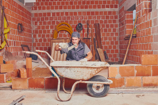 istock Real construction worker bricklaying the wall indoors. 1126065691