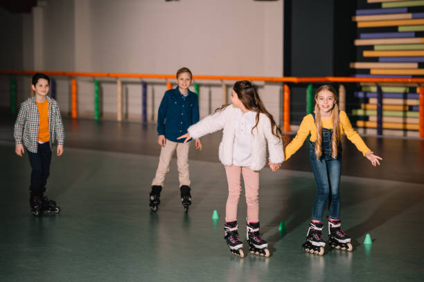 istock Friends in roller skaters laughing and holding hands 1126066162