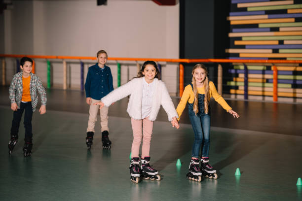 istock Excited kids in roller skates training together 1126066163