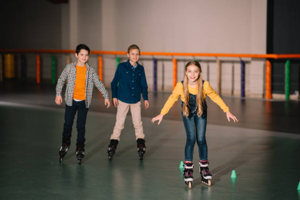 istock Smiling kids in roller skates training on rink 1126066172