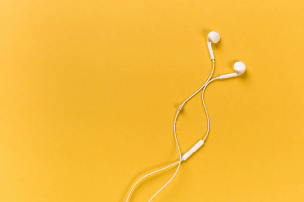 istock White earphones on orange background 1126067126