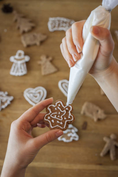 Christmas gingerbread icing decorating process. Homemade sweet cookies