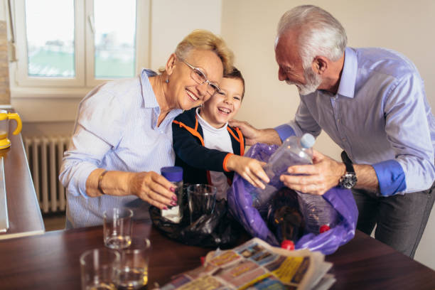 istock Boy with grandparents separating recyclable trash at home 1126067975