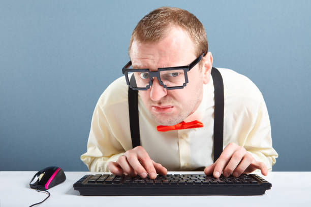 Nerd Guy Typing On Computer Keyboard Stock Photo - Download Image Now -  Nerd, Typing, Eyeglasses - iStock