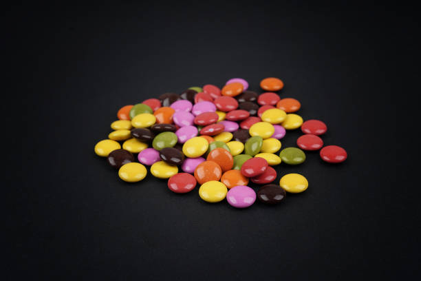istock Colorful candies on black background 1126070484