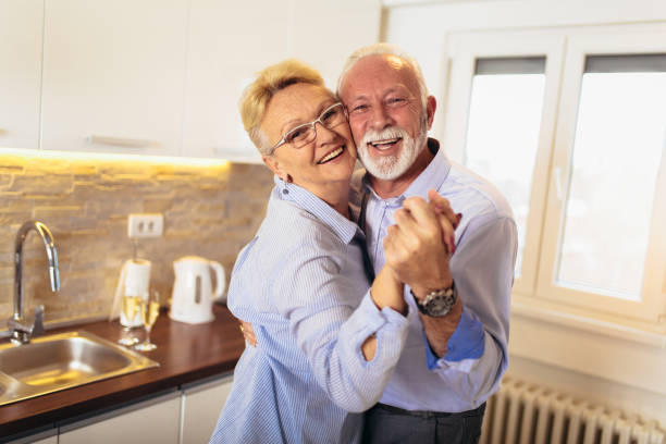 istock Senior couple dancing together in kitchen 1126072025