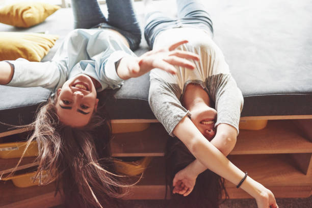 istock Two beautiful young twins sisters spending time together with pillows. Siblings having fun at home concept 1126072561