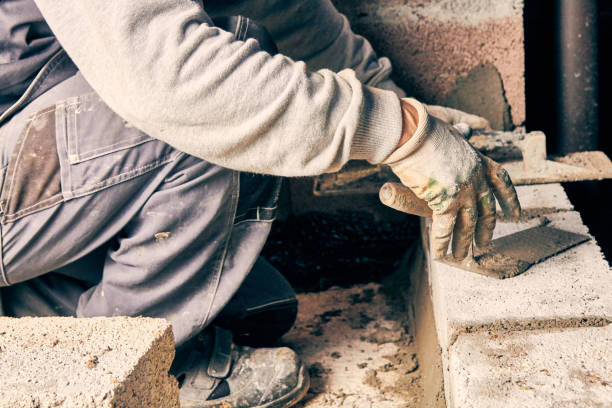 istock Real construction worker bricklaying the wall indoors. 1126073639