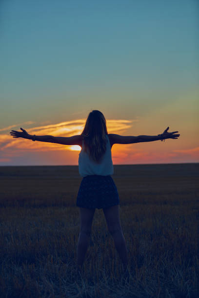 istock Cute young woman jumping in a wheat field. 1126074493