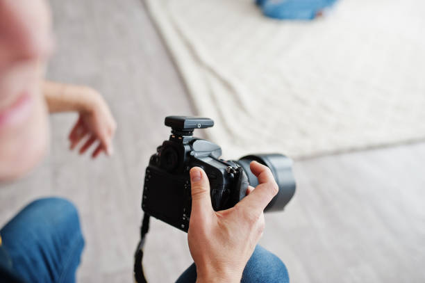 istock Photographer shooting hands close up and model posing on background at studio. 1126075202