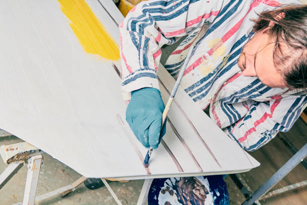 istock Artist using paint brush for making artificial wood texture. 1126075682