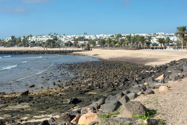 istock Stones opening during the low tide. Beach in Costa Teguise. 1126076509