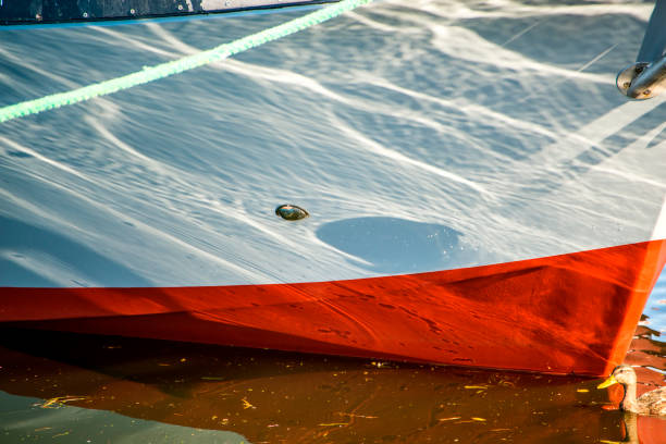 istock Mooring line of a trawler in backlight with water reflections