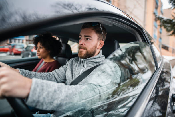 istock Two people looking outside the window and driving the car 1126078560