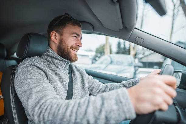 istock Young caucasian man driving the car 1126078890