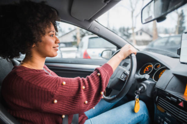Young African American woman driving the car Young African American woman driving the car driver occupation stock pictures, royalty-free photos & images
