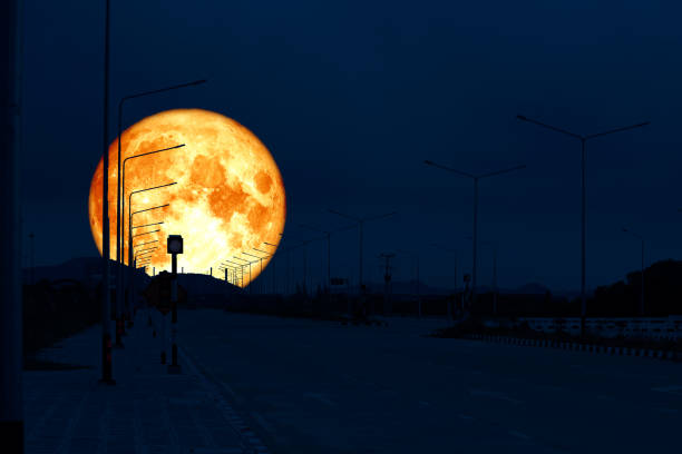 istock super blood moon back on silhouette industry road night sky 1126079966