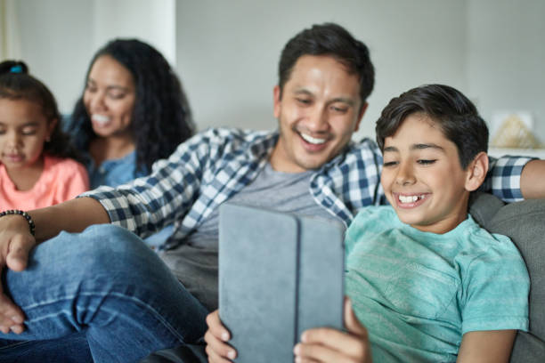 istock Happy boy with family using digital tablet at home 1126081344