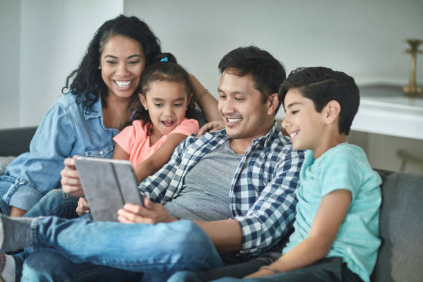 istock Multi-ethnic family taking selfie on digital tablet 1126081346