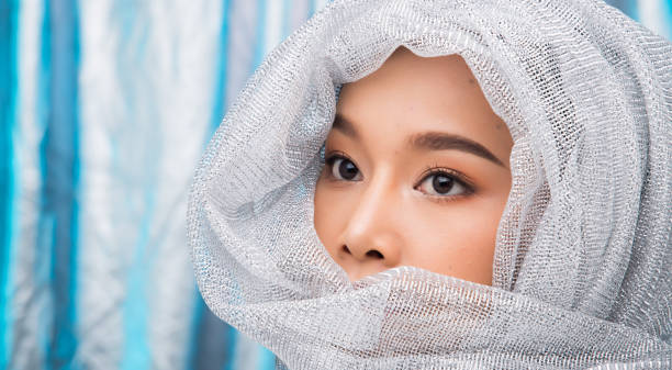 istock Asian black hair woman silver blue ice background 1126081449