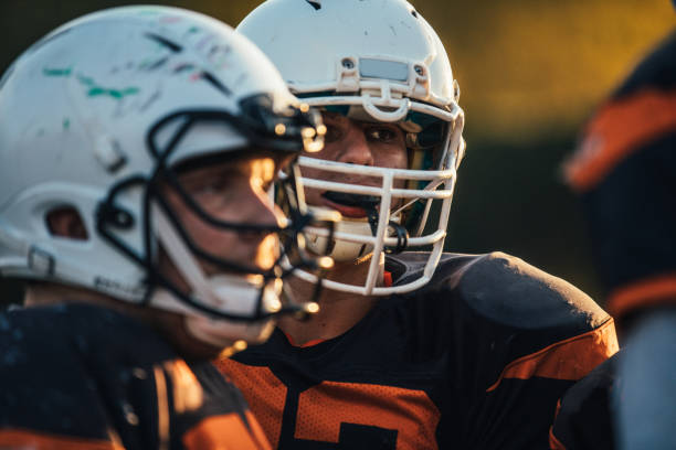 istock Two Football players with helmets 1126083087