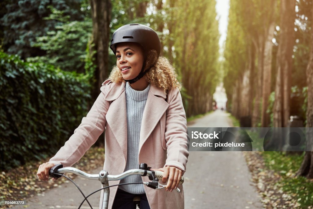 Taking the road less travelled Cropped shot of an attractive young woman out for a cycle through the woods 20-29 Years Stock Photo