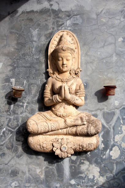 Sitting praying buddha statue with small candle holders