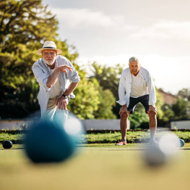 старший человек бросали булы стоял в положении - africa senior adult friendship men стоковые фото и изображения