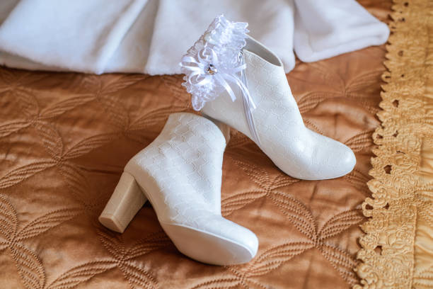 White boots for the bride Short white boots for bride and garter wedding boots stock pictures, royalty-free photos & images