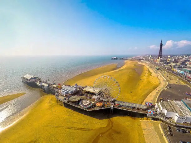 Aerial footage, drone view, of the famous Blackpool Tower and beach from the sky on a beautiful Summers day on one of Great Britains most popular holiday destinations