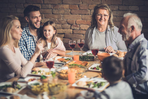 istock Happy multi-generation family enjoying in conversation during lunch at dining table. 1126086462