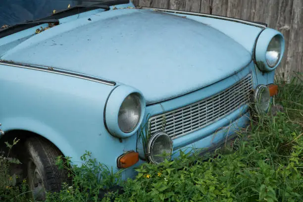 Photo of Old Eastern Europe GDR car is in the green meadow, blue oldtimer car