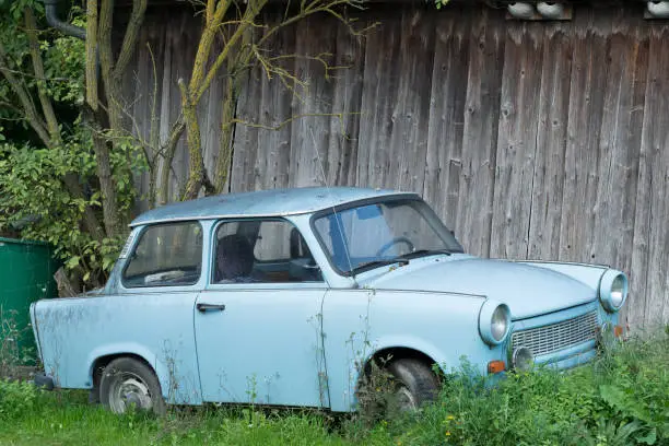 Photo of Old Eastern Europe GDR car is in the green meadow, blue oldtimer car